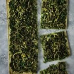 FLATBREAD WITH KALE PESTO, GREEN PEAS, AND FIDDLEHEADS