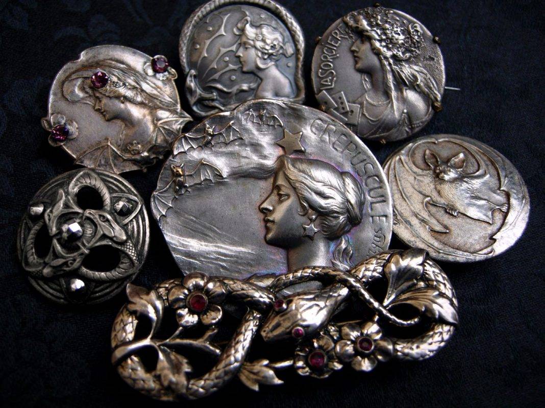 Serpents and Sorceresses—a decadent assortment of antique Art Nouveau brooches and buttons, including interlaced serpents accented with shimmering garnets and marcasite, a fluttering of bats, plus the witchy women who are perfectly content to share their time with either (and perhaps be convinced to tell your fortune while doing so).
