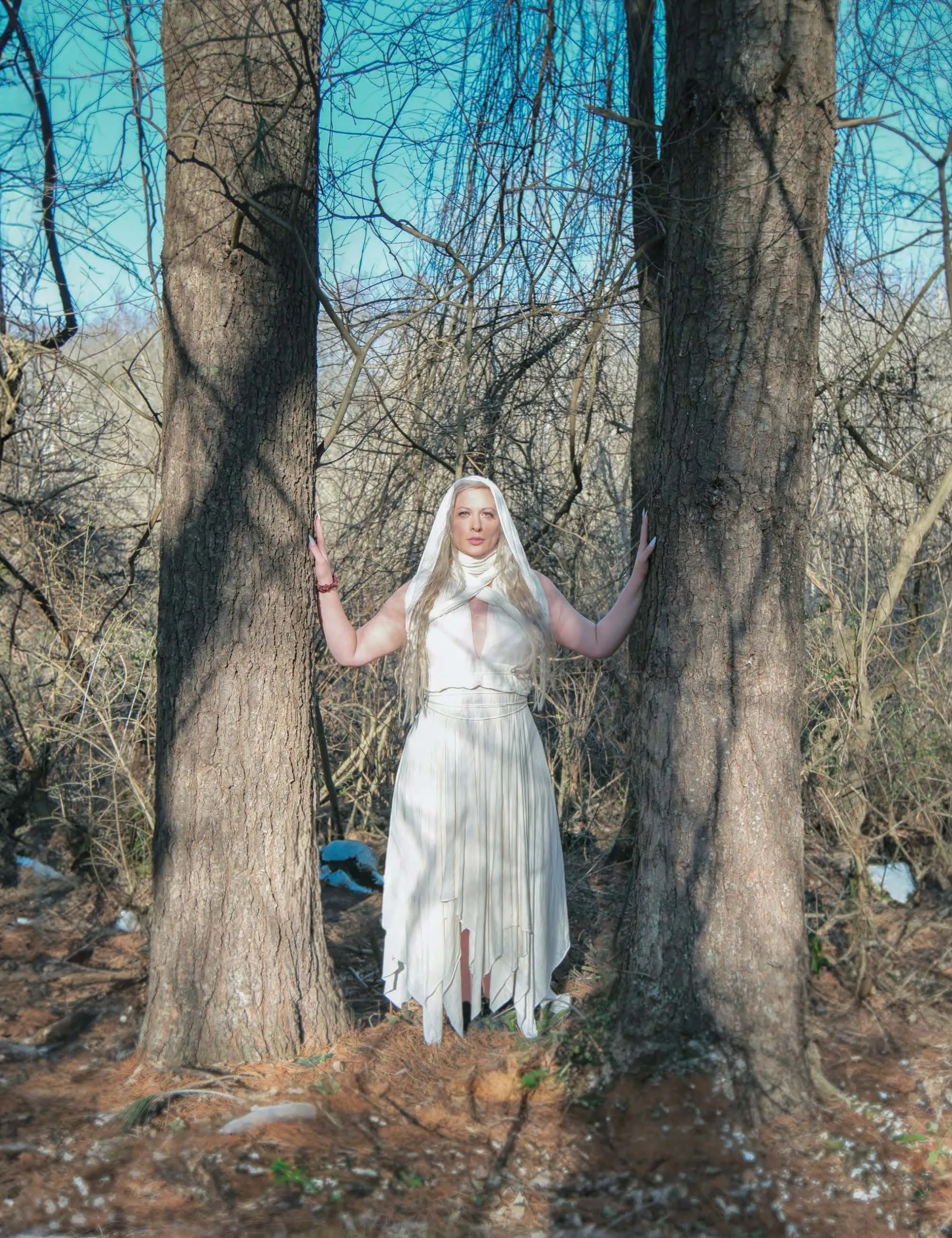 Winter Enchantment: Ceramicist Rachael Platt holding a lit manifesting jar under the full moon, surrounded by illuminated jars in a forest setting. Photography by steve parke